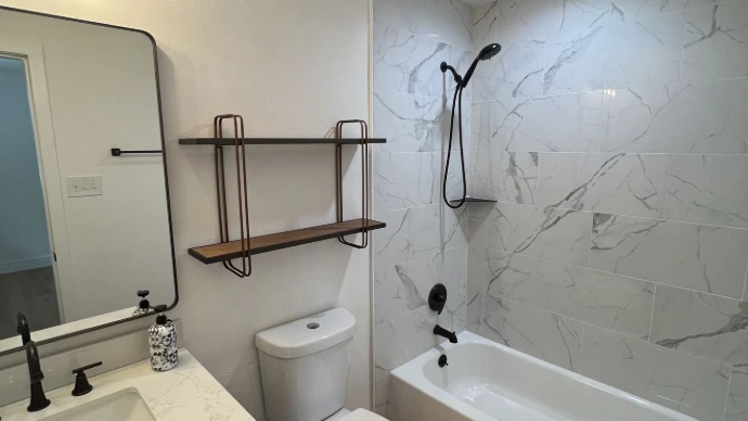Modern bathroom with tub and white 12x24 tile