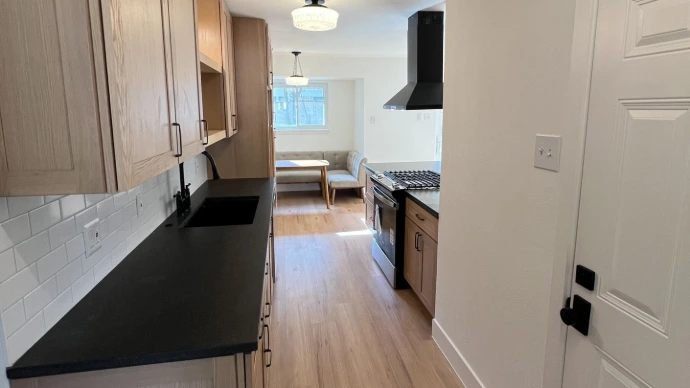 Modern Kitchen with natural wood shaker doors and black granite countertops