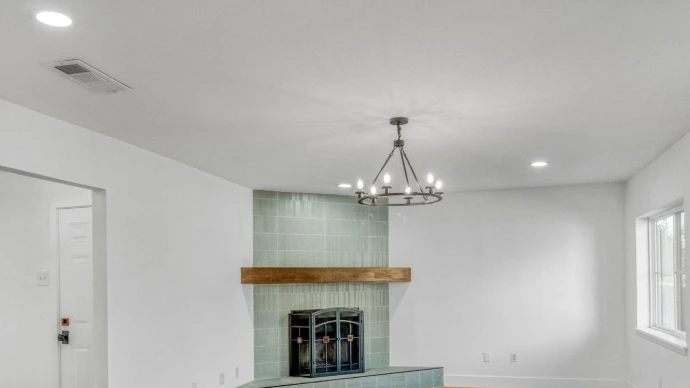LVP floor with green tiled fireplace